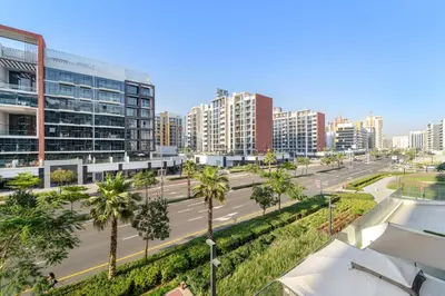 a city street with palm trees and buildings at FIRST CLASS Studio Urban Elegance in Dubai