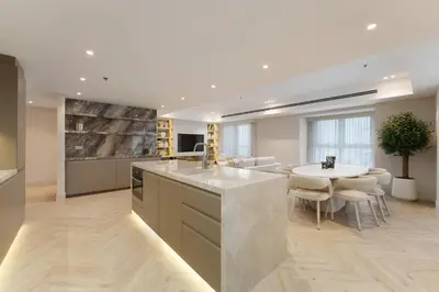 a kitchen with a large island and a dining room at Daniels 4BR At Princess Tower with Marina and Sea view in Dubai