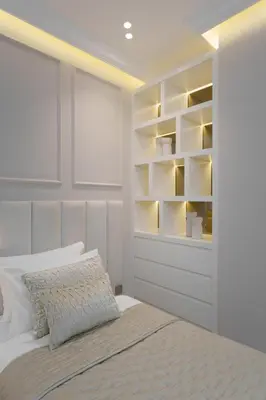 a bedroom with a large bed with white shelves at Daniels 4BR At Princess Tower with Marina and Sea view in Dubai