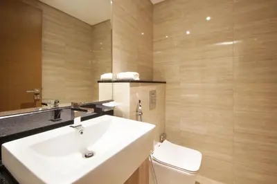 a bathroom with a white sink and a toilet at Stylish 2BR Apartment by Missoni near Dubai Mall in Dubai