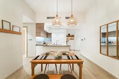 a kitchen with a wooden table in a room at FIRST CLASS 1BR Elegant Marina Hideaway in Dubai