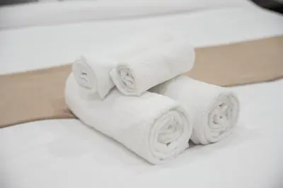 a pile of white towels on a bed at AirDXB - Luxurious 2-Bedroom Apartment in Downtown - Sleeps 4 with Iconic Burj Khalifa Views in Dubai