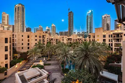 a view of a city with tall buildings and palm trees at AirDXB - Luxurious 2-Bedroom Apartment in Downtown - Sleeps 4 with Iconic Burj Khalifa Views in Dubai