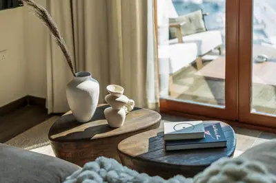 a living room with a table with two vases on it at GuestReady - West Side Studios in Palm Jumeirah in Dubai