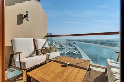 a living room with a view of a harbor at GuestReady - West Side Studios in Palm Jumeirah in Dubai