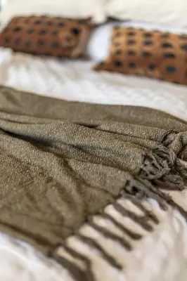 a close up of a blanket on a bed at GuestReady - West Side Studios in Palm Jumeirah in Dubai