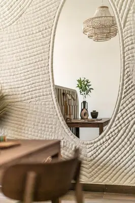 a mirror in a room with a chair and a table at GuestReady - West Side Studios in Palm Jumeirah in Dubai