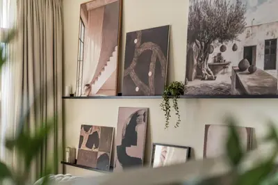 two shelves with pictures on a wall at GuestReady - West Side Studios in Palm Jumeirah in Dubai