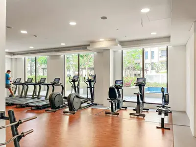 a gym with a row of treadmills and ellipticals at Premium 1BR with Iconic Skyline Views with Balcony & Pool in Dubai