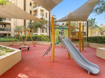 a playground with a slide and a slide at Premium 1BR with Iconic Skyline Views with Balcony & Pool in Dubai