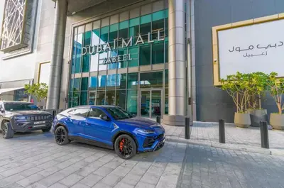 a blue car parked in front of a building at Vogue Downtown Views II with Direct Access to Dubai Mall Via a Climate Controlled Bridge, Two Bedroom Apartment with Balcony and Burj Khalifa View in Dubai