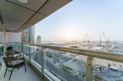 a balcony with a chair and a view of a city at Daniels 2BR at Princess Tower with Sea View in Dubai