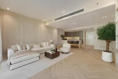 a living room with a white couch and a table at Daniels 1BR at Shoreline with Sea View in Dubai