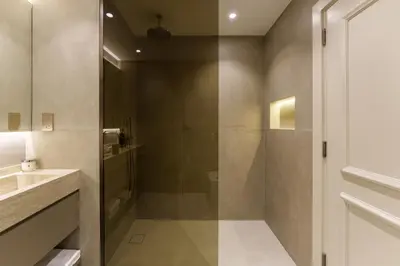a bathroom with a shower and a sink at Daniels 1BR at Shoreline with Sea View in Dubai