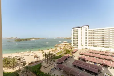 an aerial view of a resort and the beach at Daniels 1BR at Shoreline with Sea View in Dubai