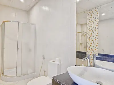 a bathroom with a tub and a toilet and a sink at MK Residence JVC in Dubai