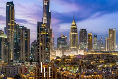 a view of a city skyline at night at LUX The Executive Burj Khalifa View Suite 2 in Dubai