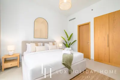 a bedroom with a white bed in a room at LUX The Executive Burj Khalifa View Suite 2 in Dubai
