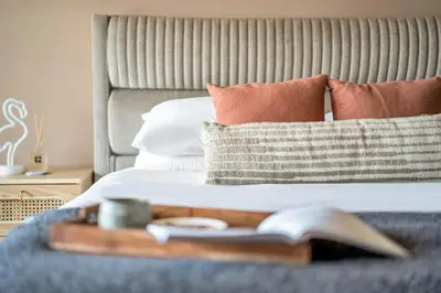 a bed with a tray with a book on it at GuestReady - Modern urban retreat in JLT in Dubai