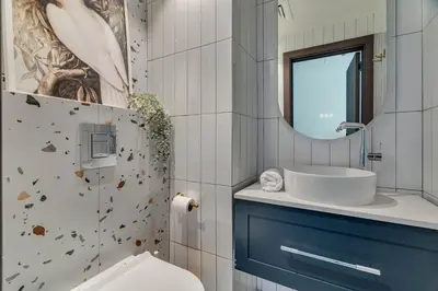 a bathroom with a toilet and a sink and a mirror at GuestReady - Modern urban retreat in JLT in Dubai
