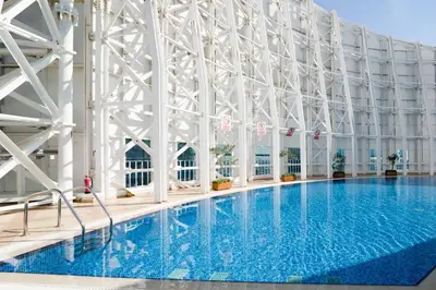 a large swimming pool with a large white building at GuestReady - Modern urban retreat in JLT in Dubai
