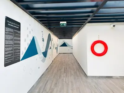 a hallway with a red circle on the wall at Peaceful 2 Bed Oasis Suite in JVC in Dubai