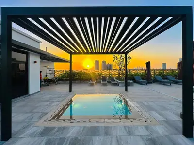 a pool on a patio with a view of the city at Peaceful 2 Bed Oasis Suite in JVC in Dubai