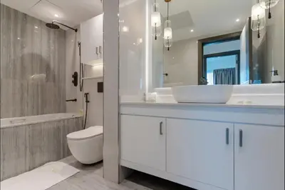 a bathroom with a white sink and a toilet at AWS Holiday Homes - Style in Downtown in Dubai