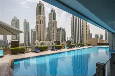 a large swimming pool with a view of a city at AWS Holiday Homes - Style in Downtown in Dubai