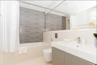 a bathroom with a sink and a toilet and a tub at AWS Holiday Homes - Amazing Beachfront Stay in Dubai