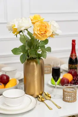 a table with a vase of flowers and a glass of wine at Dubai Eye & Sea View 2BR Marina & Beach Walk in Dubai