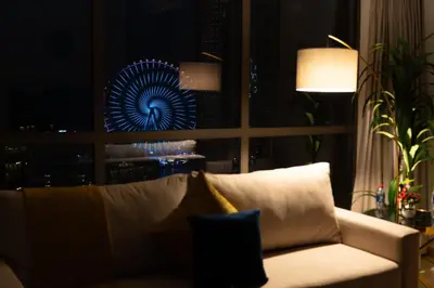 a living room with a couch and a blue fan at Dubai Eye & Sea View 2BR Marina & Beach Walk in Dubai