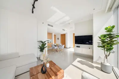 a living room with a couch and a table at FIRST CLASS 1BR Modern Luxury on High Floor in Dubai