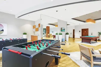a room with a ping pong table in the middle at Burj Khalifa & Fountain From Your Balcony Near Dubai Mall & Metro in Dubai