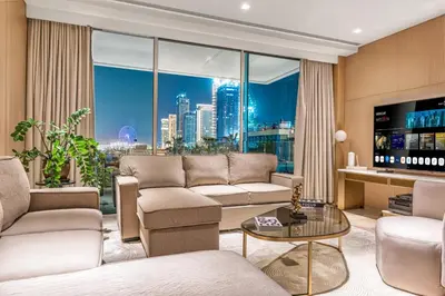 a living room with a couch and a large window at FIVE Palm Jumeirah Premier Apartments in Dubai