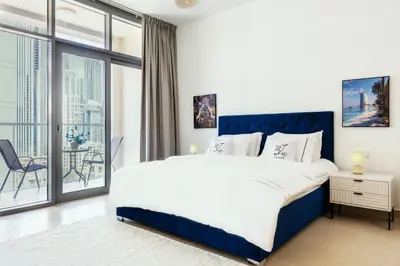 a bedroom with a large bed and a large window at FULL Burj Khalifa View Luxury Stay in Downtown in Dubai