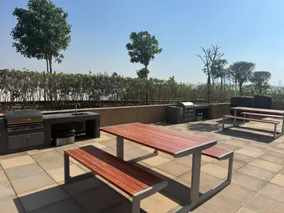 a patio with two benches and a grill and a picnic table at Studio Free Parking Pet Friendly Near Downtown Dubai in Dubai