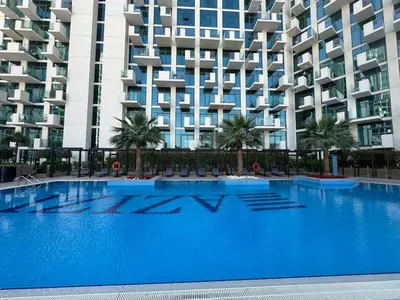 a large blue swimming pool in front of a building at Studio Free Parking Pet Friendly Near Downtown Dubai in Dubai