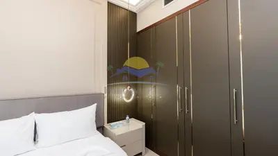 a bedroom with a bed and a large wardrobe at Holidays R Us villa 4 bedroom boulevard view in Dubai