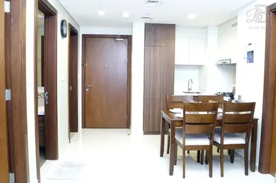a kitchen and dining room with a table and chairs at Stylish 2BR Apt in Business Bay Burj & Creek Views in Dubai