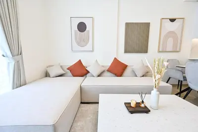 a white living room with a white couch at Stunning 1 Bdr luxury residence at JVC in Dubai