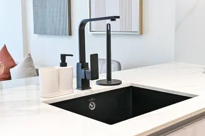 a black kitchen sink in a white counter top at Stunning 1 Bdr luxury residence at JVC in Dubai