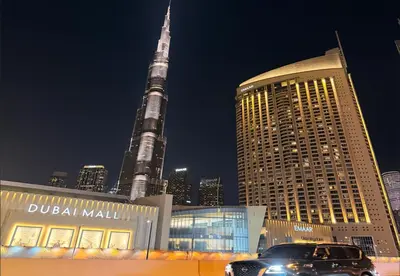 a car parked in front of dubai mall with the tallest building at Luxurious Studio with Burj Khalifa View Direct Dubai Mall Access - Kempinski Residence in Dubai
