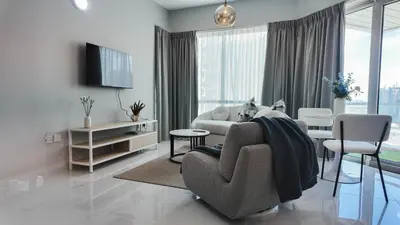 a living room with a couch and chairs and a tv at Sky High 2BR Stay Amazing Marina Views Near Metro & Mall in Dubai