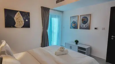 a bedroom with a bed with a stuffed animal on it at Sky High 2BR Stay Amazing Marina Views Near Metro & Mall in Dubai