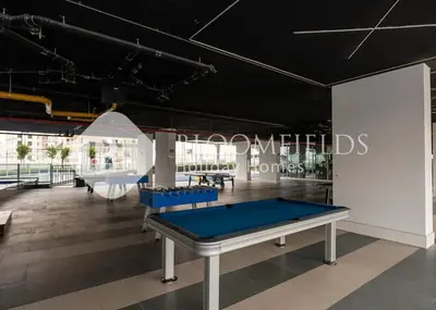 a ping pong table in a room with a pool table at Bloomfields Hidden Gem 1Br with Private Pool in Dubai
