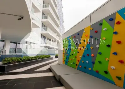 a climbing wall on the side of a building at Bloomfields Hidden Gem 1Br with Private Pool in Dubai