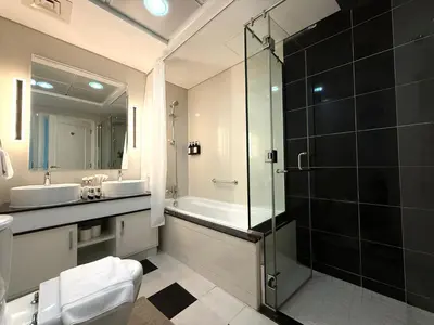 a bathroom with a shower and a toilet and a sink at Stylish 1BR, 2Min to Dubai Mall in Dubai