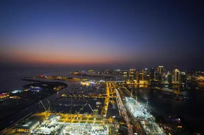 an aerial view of a city at night at 49 -Elegant Princess Tower Family Apartment with Palm View, Balcony & Pool in Dubai
