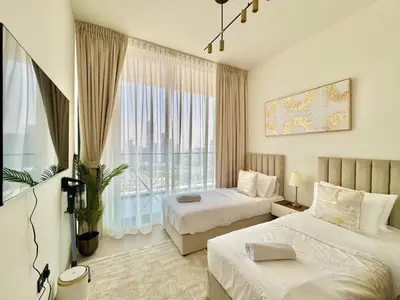 a hotel room with two beds and a large window at Elegant 2br Jvc Private Pool, Balcony & Parking in Dubai